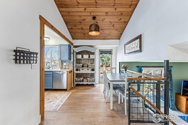 dining room with light wood-style flooring, wooden ceiling, and lofted ceiling