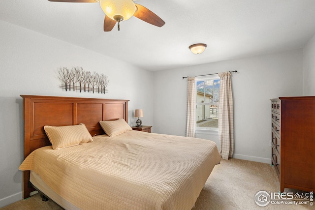 bedroom with a ceiling fan, light colored carpet, and baseboards