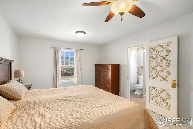 bedroom featuring a ceiling fan and connected bathroom