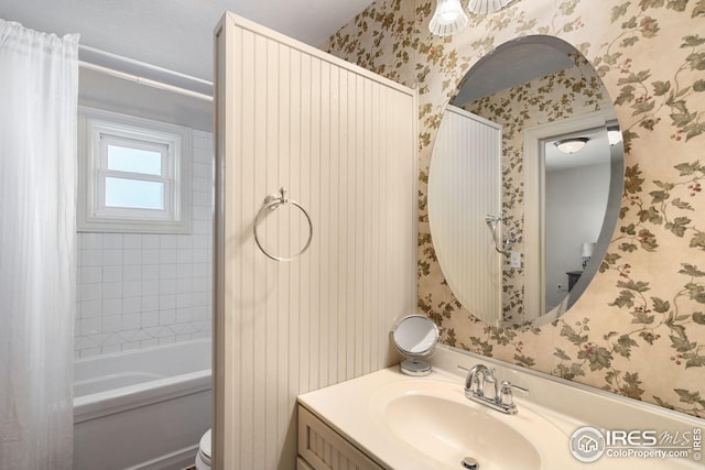 bathroom with toilet, shower / tub combo, vanity, and wallpapered walls