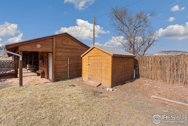 view of shed featuring fence