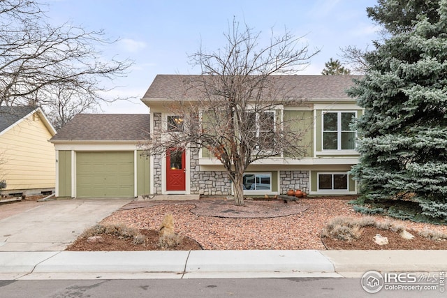 view of front of house featuring stone siding, roof with shingles, an attached garage, and concrete driveway