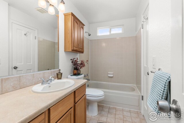 full bath featuring toilet, bathing tub / shower combination, visible vents, and vanity