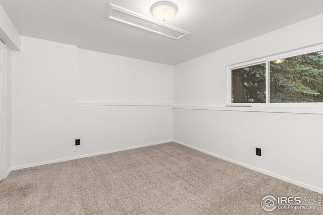 carpeted empty room with baseboards