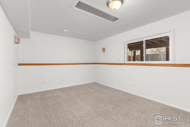 carpeted empty room with baseboards