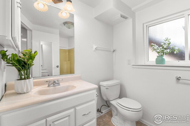 bathroom with baseboards, visible vents, vanity, and toilet