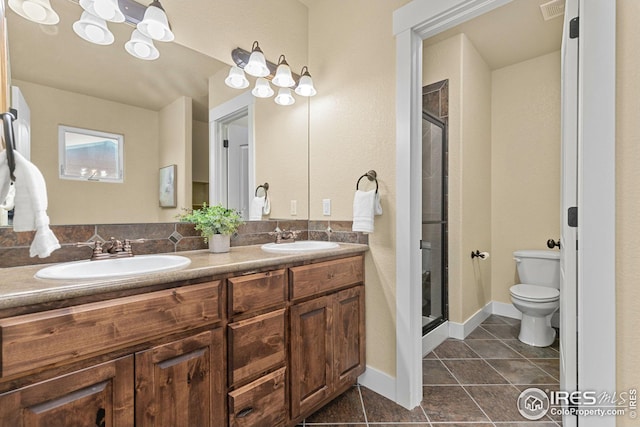 5850 Dripping Rock Ln, Fort Collins, CO 80528 - bathroom featuring toilet, a shower stall, double vanity, and a sink