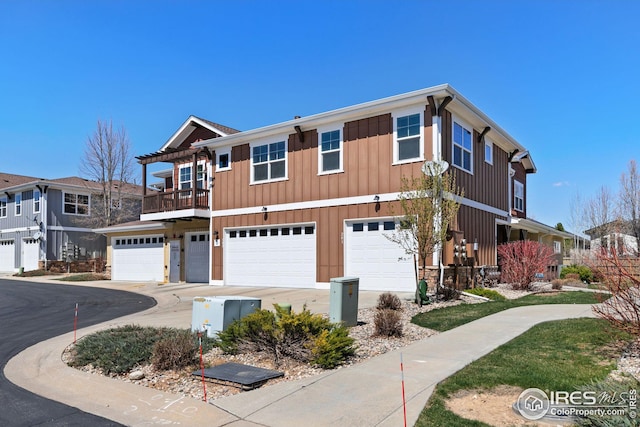 5850 Dripping Rock Ln, Fort Collins, CO 80528 - multi unit property featuring driveway, board and batten siding, an attached garage, and a balcony