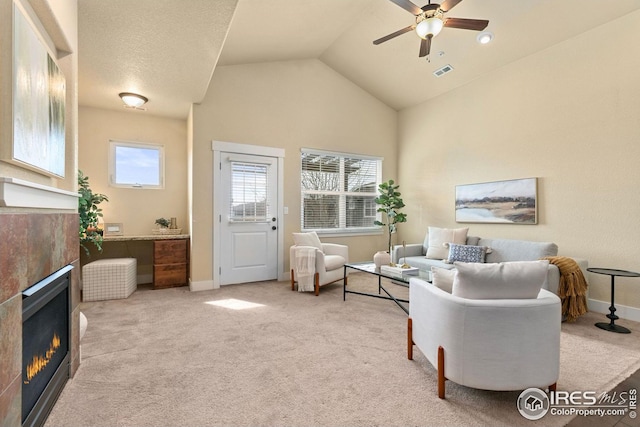 5850 Dripping Rock Ln, Fort Collins, CO 80528 - carpeted living room with high vaulted ceiling, visible vents, baseboards, a ceiling fan, and a tiled fireplace