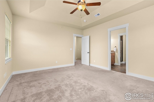 5850 Dripping Rock Ln, Fort Collins, CO 80528 - unfurnished bedroom featuring carpet, a raised ceiling, visible vents, ensuite bathroom, and baseboards
