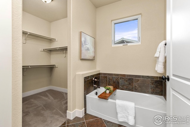 5850 Dripping Rock Ln, Fort Collins, CO 80528 - full bath with a spacious closet, tile patterned floors, a bath, and baseboards