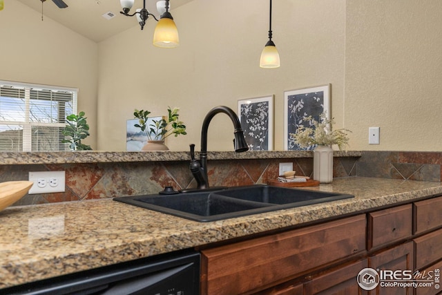5850 Dripping Rock Ln, Fort Collins, CO 80528 - kitchen featuring pendant lighting, vaulted ceiling, a sink, dark brown cabinets, and dishwasher