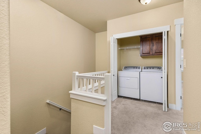 5850 Dripping Rock Ln, Fort Collins, CO 80528 - laundry area featuring light carpet, independent washer and dryer, and cabinet space
