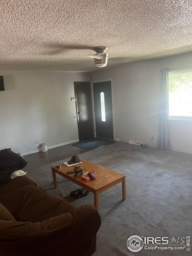 living area featuring a textured ceiling