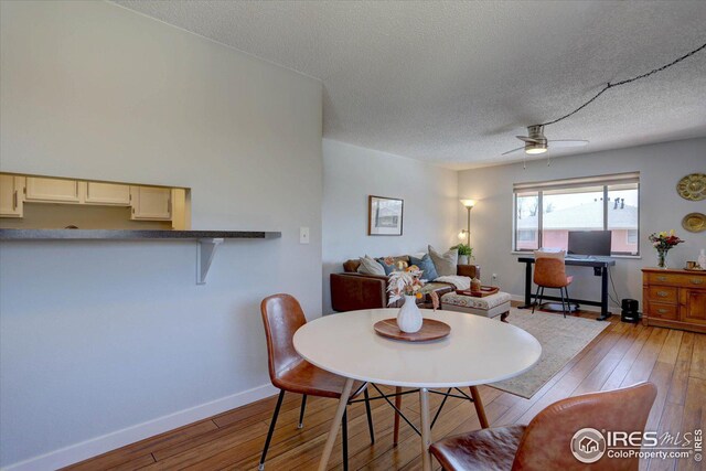 1105 Bacchus Dr Unit 8, Lafayette, CO 80026 - dining area featuring a ceiling fan, a textured ceiling, baseboards, and hardwood / wood-style flooring