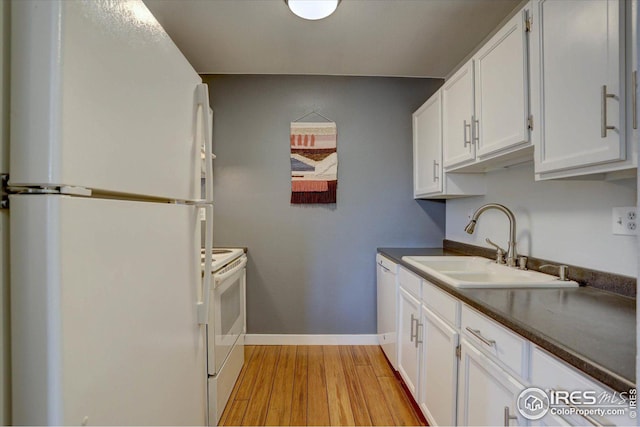 1105 Bacchus Dr Unit 8, Lafayette, CO 80026 - kitchen featuring light wood-style floors, dark countertops, white appliances, and a sink