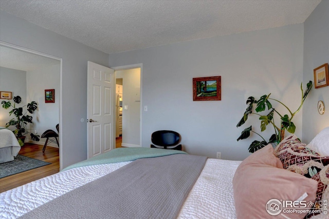 1105 Bacchus Dr Unit 8, Lafayette, CO 80026 - bedroom with a textured ceiling and wood finished floors