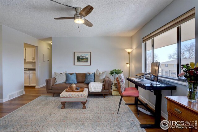 1105 Bacchus Dr Unit 8, Lafayette, CO 80026 - living area featuring baseboards, visible vents, a ceiling fan, wood finished floors, and a textured ceiling