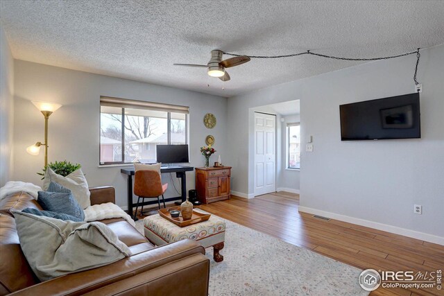 1105 Bacchus Dr Unit 8, Lafayette, CO 80026 - living room featuring baseboards, visible vents, a ceiling fan, wood finished floors, and a textured ceiling