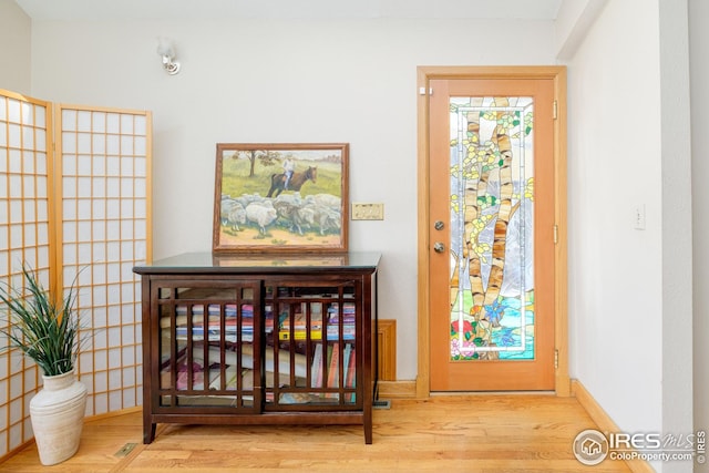 interior space featuring wood finished floors and baseboards