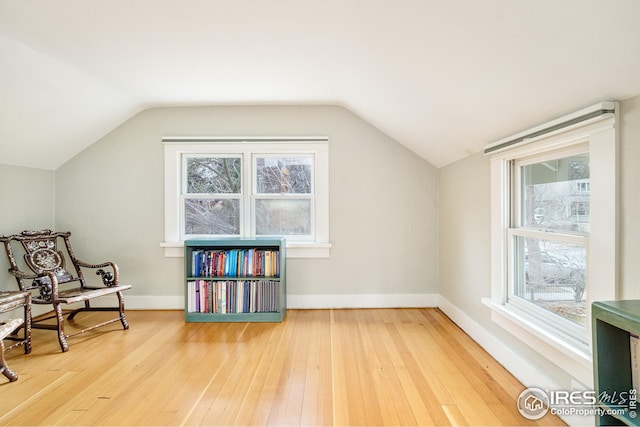 bonus room with lofted ceiling, baseboards, and hardwood / wood-style floors