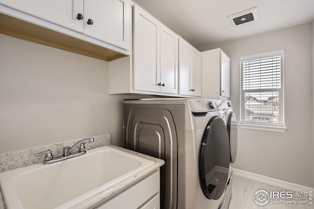 5541 Tullamore Ct, Timnath, CO 80547 - laundry area featuring cabinet space, washing machine and dryer, and baseboards