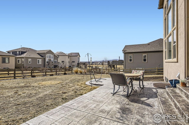 5541 Tullamore Ct, Timnath, CO 80547 - view of patio featuring fence, a residential view, and outdoor dining space