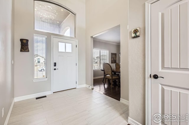 5541 Tullamore Ct, Timnath, CO 80547 - foyer entrance with baseboards, crown molding, and light wood finished floors