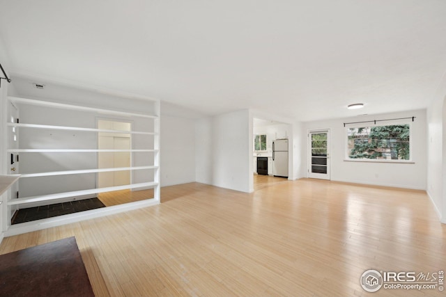 unfurnished living room featuring light wood finished floors