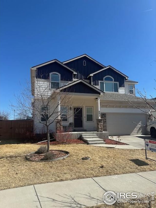 view of front facade with concrete driveway, an attached garage, and fence