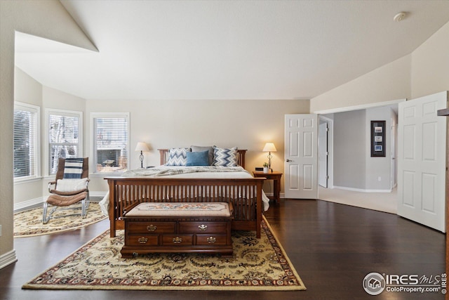 bedroom featuring dark wood finished floors, baseboards, and lofted ceiling