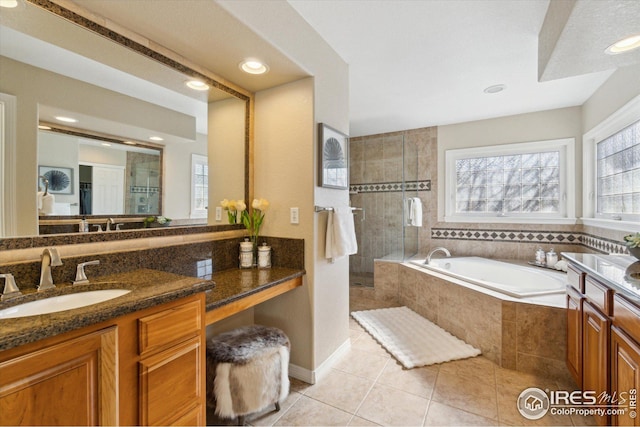 full bath with tile patterned flooring, a bath, vanity, and tiled shower