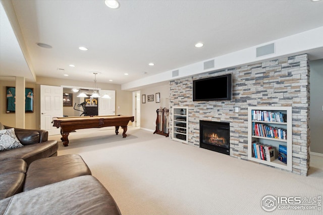 playroom with visible vents, a glass covered fireplace, and carpet flooring