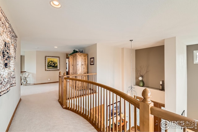 corridor with recessed lighting, carpet, baseboards, and an upstairs landing