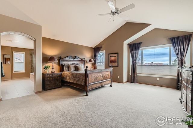 bedroom with vaulted ceiling, baseboards, a ceiling fan, ensuite bath, and carpet floors