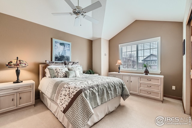 bedroom featuring ceiling fan, vaulted ceiling, and light colored carpet