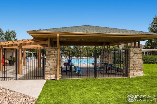 surrounding community featuring fence, a gate, a yard, and a gazebo