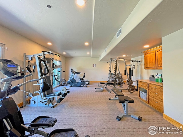 4101 Crittenton Ln Unit 208U, Wellington, CO 80549 - exercise room featuring light colored carpet, visible vents, and baseboards