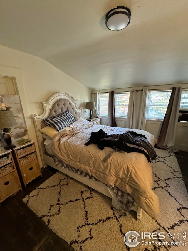 bedroom featuring vaulted ceiling and wood finished floors