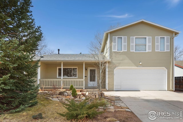 view of front of property featuring an attached garage, covered porch, and driveway