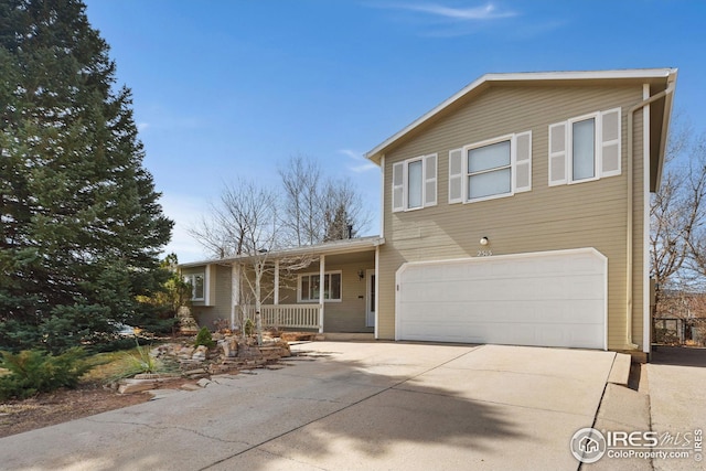 view of front of property featuring concrete driveway, an attached garage, and covered porch