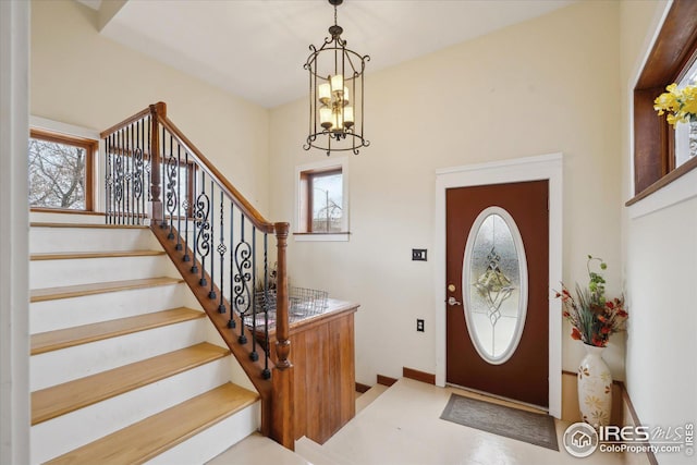 entrance foyer featuring stairs and an inviting chandelier