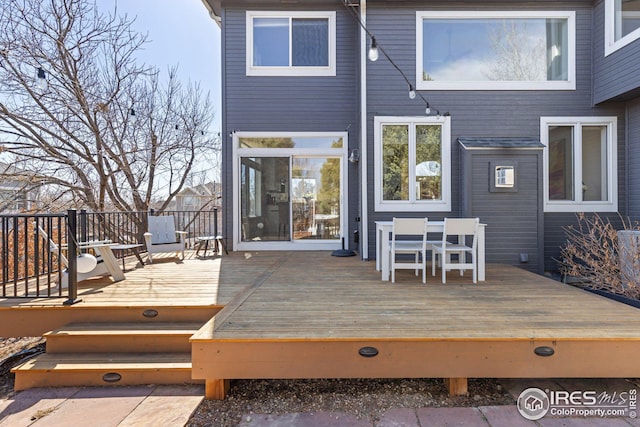 wooden deck with outdoor dining area