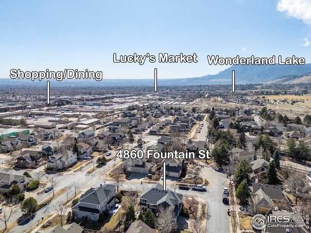 birds eye view of property featuring a mountain view and a residential view