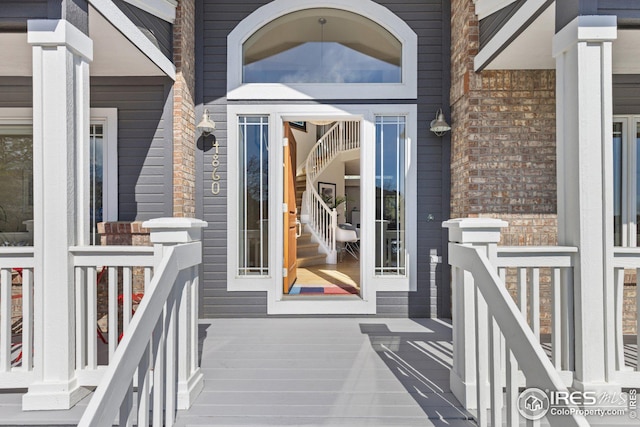 property entrance featuring brick siding