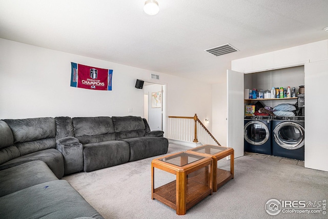 living area featuring visible vents, carpet, and washing machine and clothes dryer