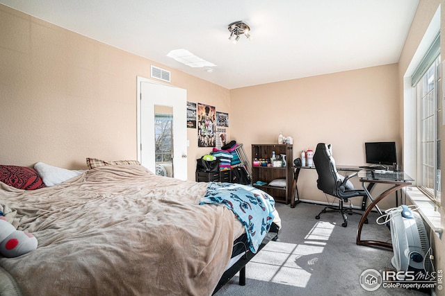 carpeted bedroom with visible vents