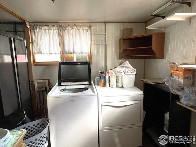 clothes washing area with washer and dryer and laundry area