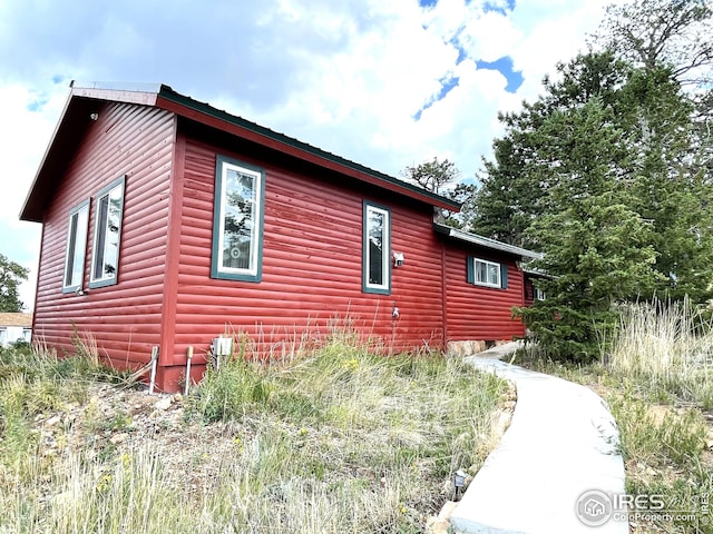 view of home's exterior featuring log veneer siding