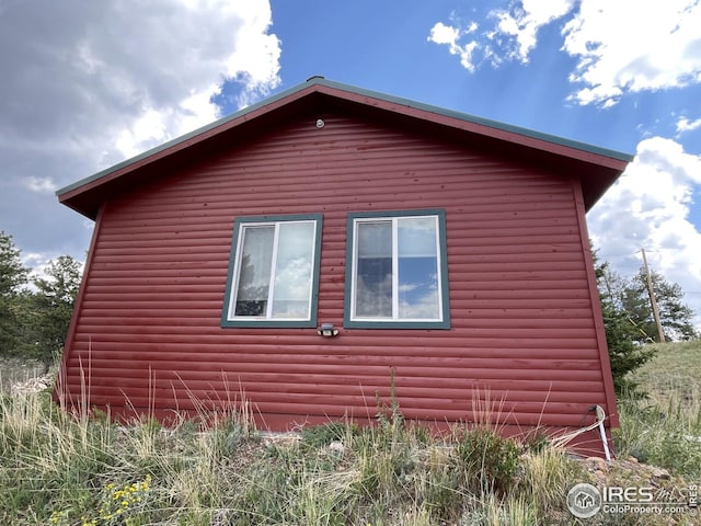 view of home's exterior with log veneer siding